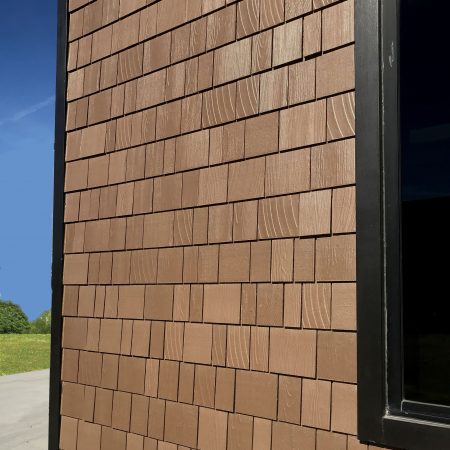 Photo of a siding product with a new multi-toned paint finish and a large range in shingle textures molded into fiber cement for a realistic look.